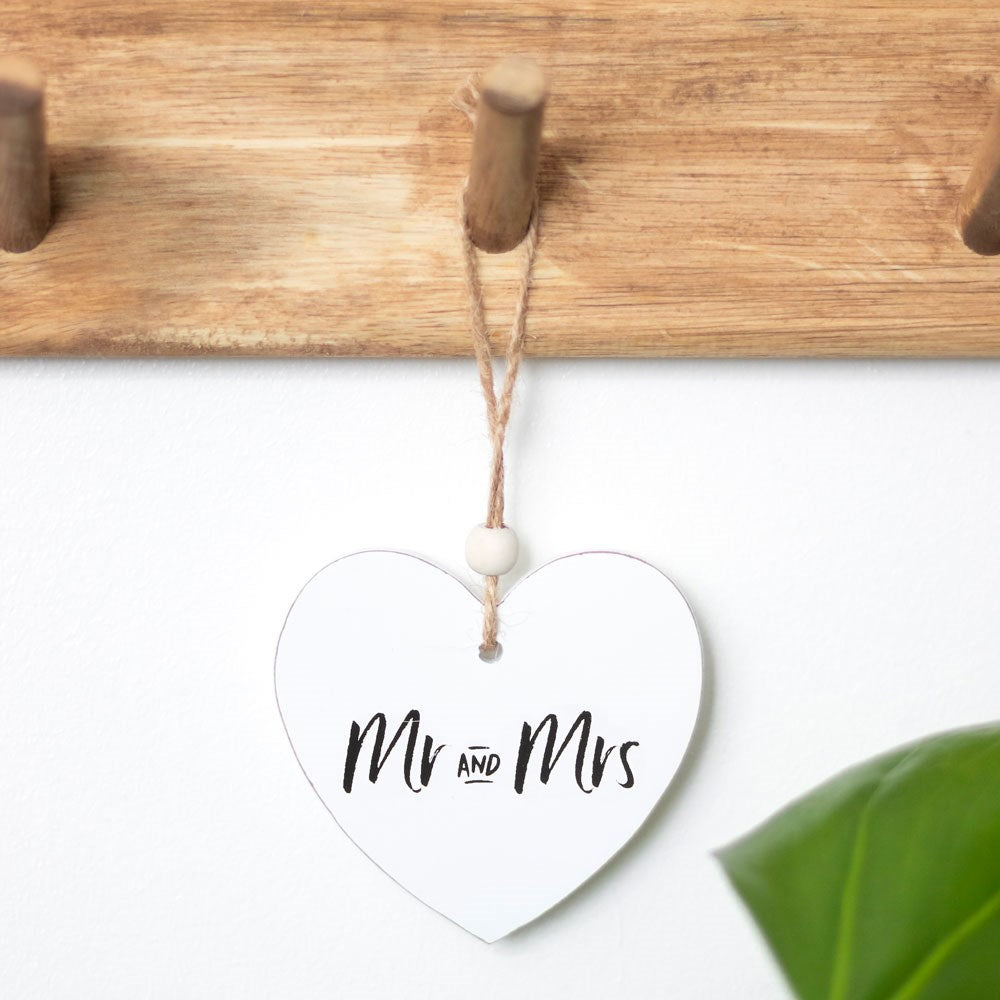 Heart-shaped sentiment sign, a beautiful wedding keepsake gift, hanging gracefully.