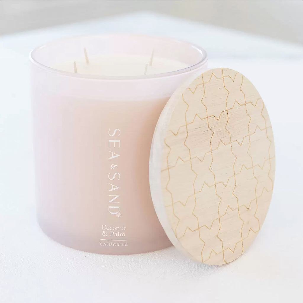 Luxurious 1.5kg Sea & Sand Fragranced Candle in Coconut and Palm Fragrance, positioned elegantly against a serene backdrop.