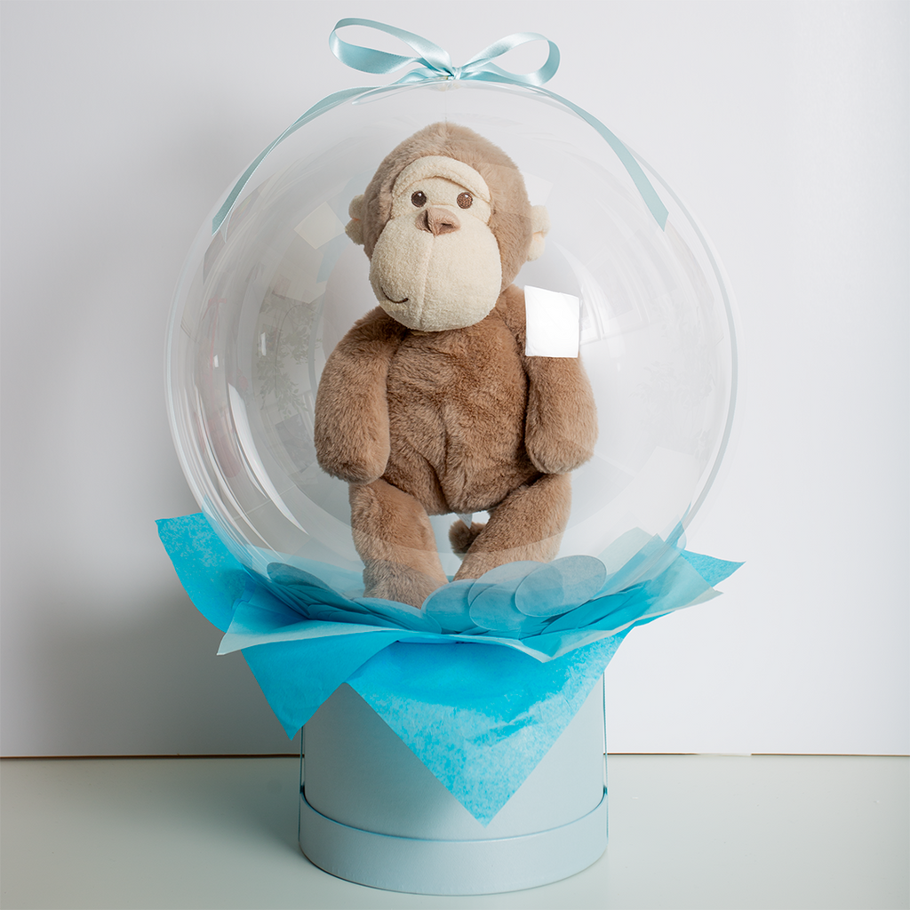 Adorable Jellycat Monkey nestled within KeiCo's confetti-filled transparent bubble balloon.