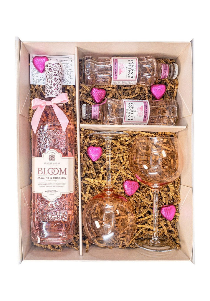 KeiCo's Bloom Jasmine & Rose Gin Gift Set displayed elegantly with pink gin, glasses, and chocolates.