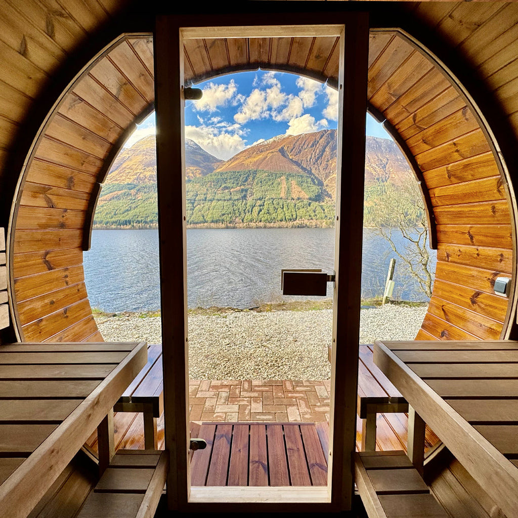 Timber barrel sauna with curved design set in a garden space – part of KeiCo’s outdoor Barrel Saunas collection.