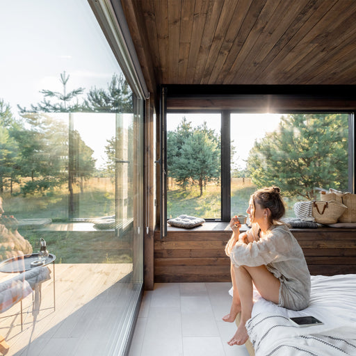 Peaceful wooden garden sanctuary surrounded by lush greenery, signifying meditation and relaxation spaces by The KeiCo.
