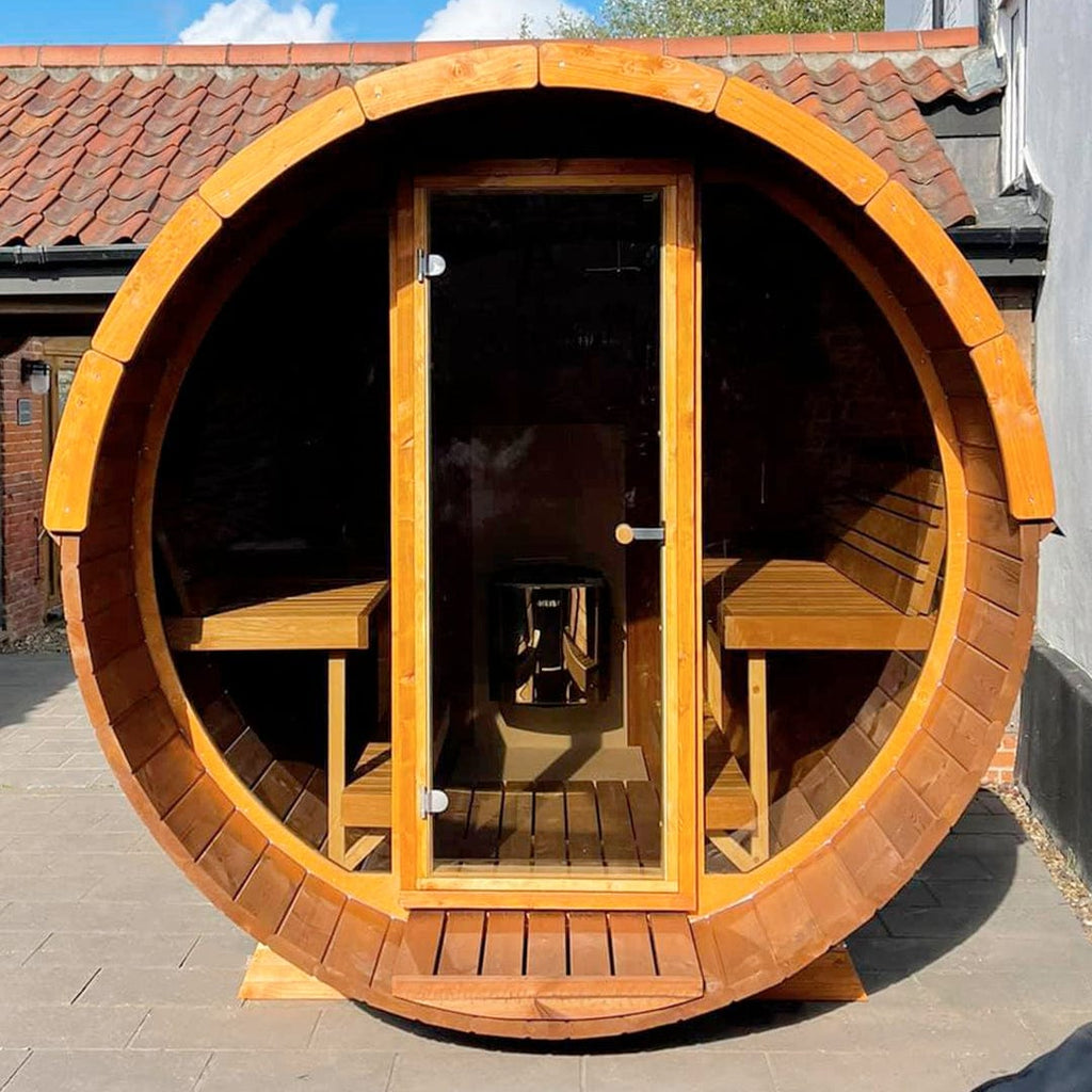 Close-up of the full glass front of the KeiCo Barrel Sauna, capturing the serene views beyond.