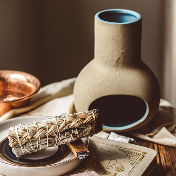 Side view of hand-thrown incense holder with earthy glaze variation