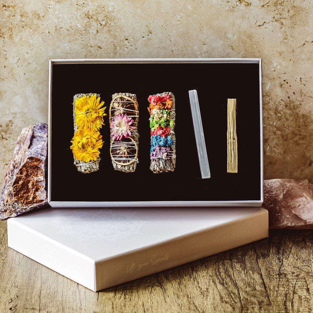 Sage smudge stick and palo santo laid on soft natural linen