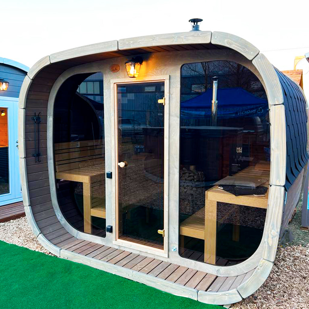 KeiCo Wellness Premium Sauna Cube shown installed in a luxury garden setting