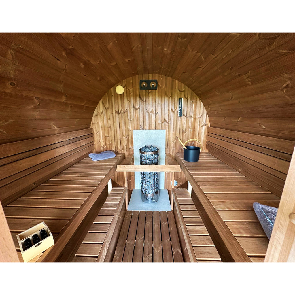 Interior of KeiCo 280 Glass Deluxe Barrel Sauna - Multi-Level Seating with Aspen Benches and Harvia Stones for Nordic Relaxation