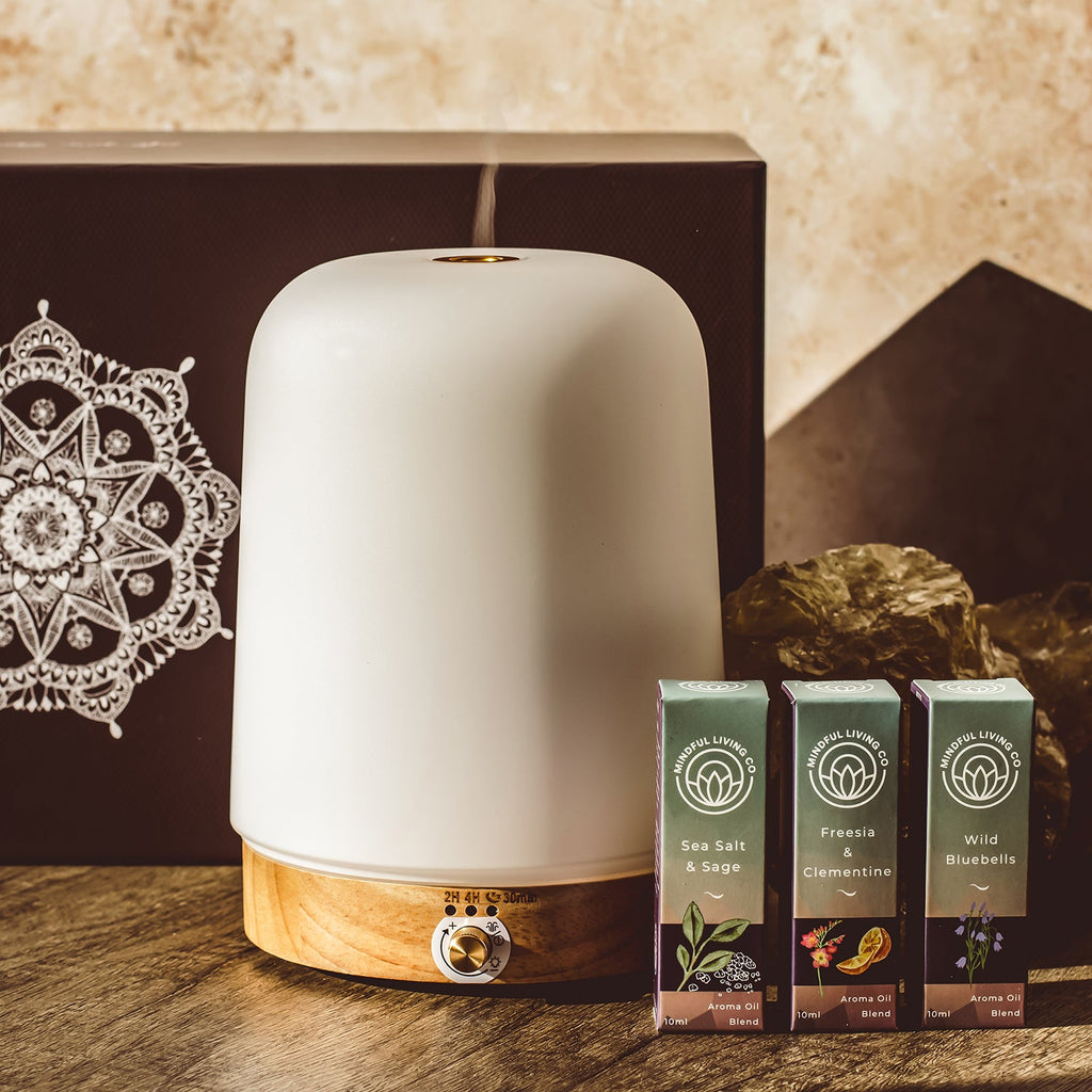 Calm white diffuser on wood surface with mist and light