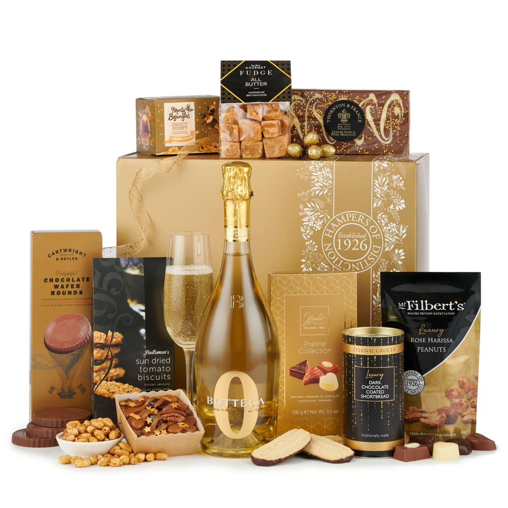A luxurious golden gift box of The Sparkling Elegance Alcohol-Free Celebration Hamper with a glimpse of the treats inside.
