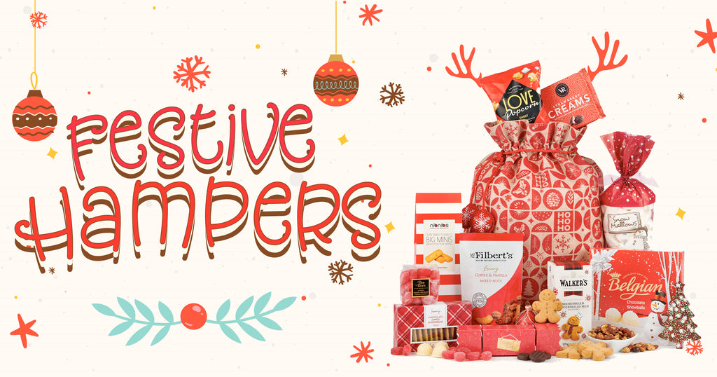 "Festive hampers banner featuring a decorative Christmas sack filled with assorted gourmet treats such as 'Love Popcorn', 'Creams' biscuits, 'Snowy Mallows', 'Mr. Filbert's Mixed Nuts', 'Walker's Shortbread', and 'Belgian Chocolate Snowballs'. The background is adorned with snowflakes, Christmas ornaments, and a whimsical holiday typography.