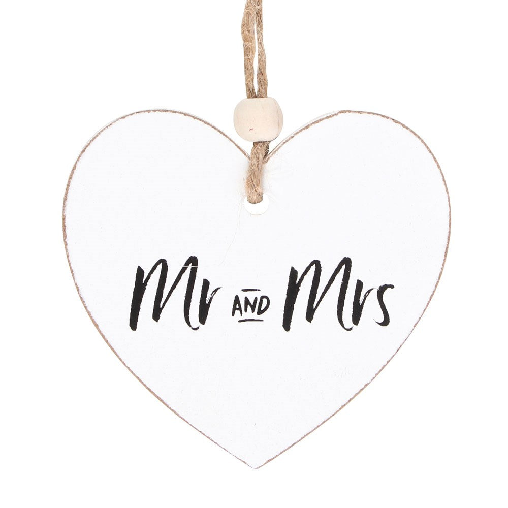 Close-up of the 'Mr and Mrs' inscription on the wooden heart sentiment sign.