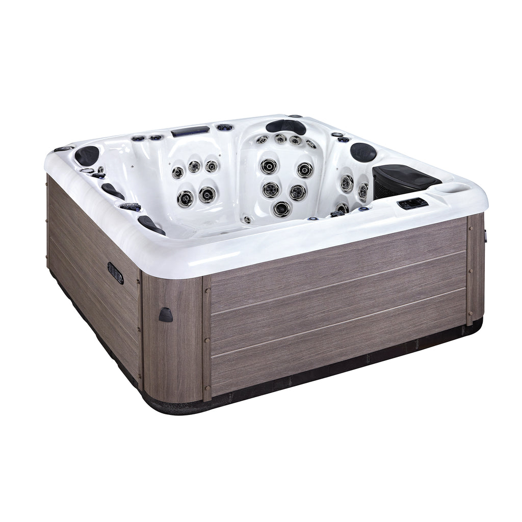 KC Serenity Spa Plus luxury 6-person hot tub with illuminated LED lights at dusk, showcasing the vibrant ambiance it adds to any garden.