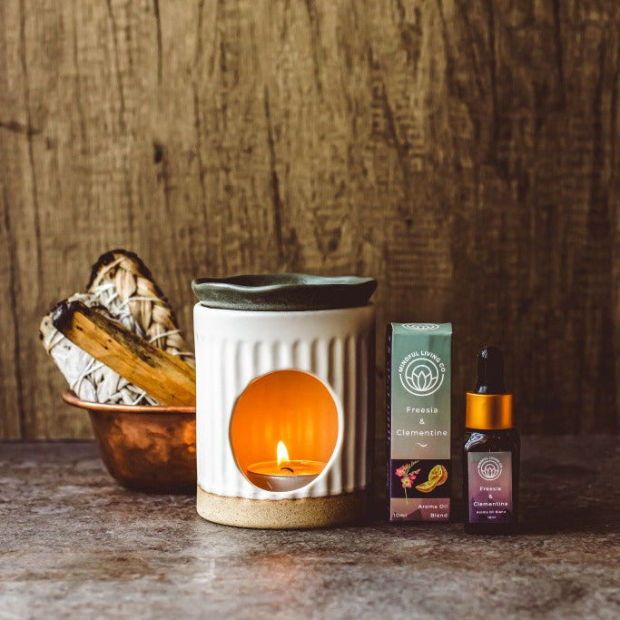 Freesia & Clementine diffuser oil beside bright citrus and soft petals – zesty and joyful.