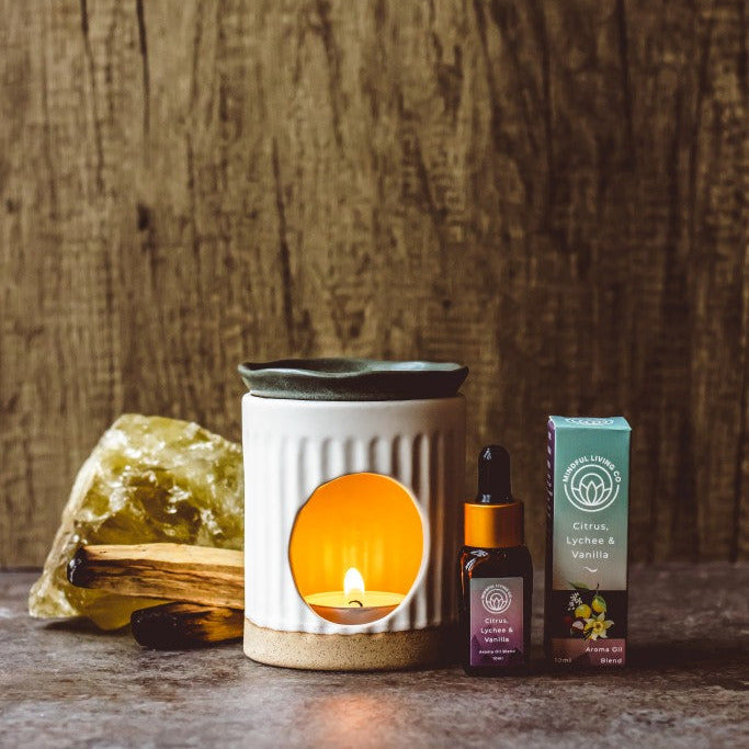Citrus Lychee & Vanilla oil bottle near tropical fruit and oil burner – lush, creamy, and vibrant.