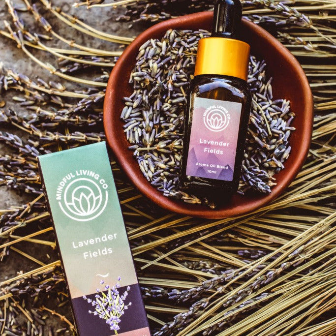 Lavender Fields fragrance oil styled with dried lavender sprigs and a glowing oil burner – soothing, floral, and serene.