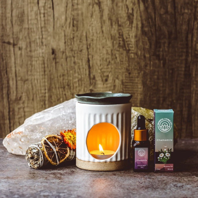 Chamomile diffuser oil styled with dried herbs and burner – soothing and gentle.
