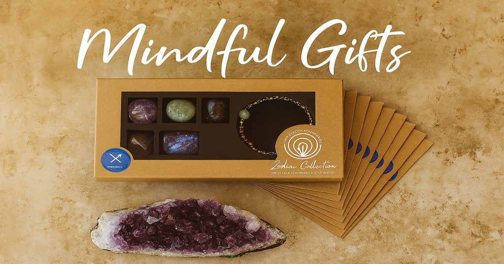 Flat lay of KeiCo's Zodiac Crystal Gift Collection featuring a gemstone and bracelet set with zodiac-themed packaging, styled on a warm stone-textured background with "Mindful Gifts" in handwritten font.