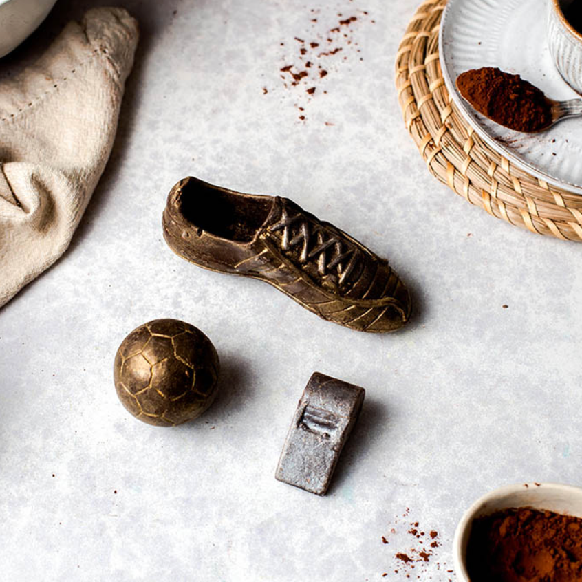 Novelty football chocolate set with golden boot and silver whistle styled on wooden board