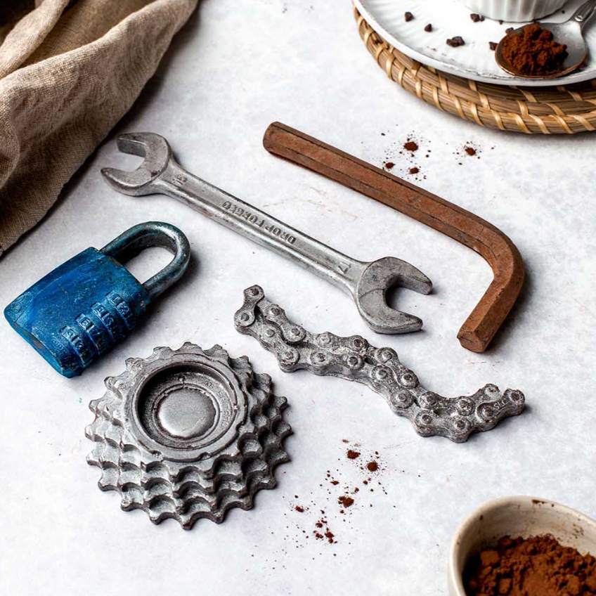 Realistic chocolate bike gear set styled on wooden board for cyclist gifting