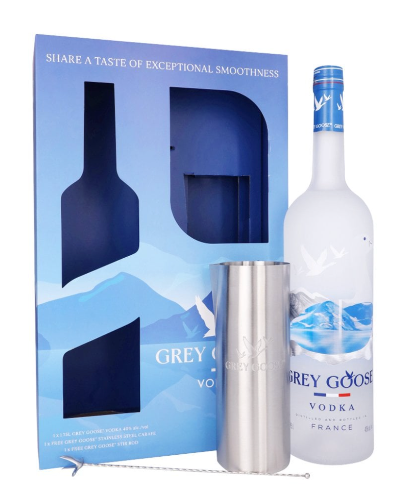 Grey Goose vodka bottle, packaging, and metal tumbler on a white background