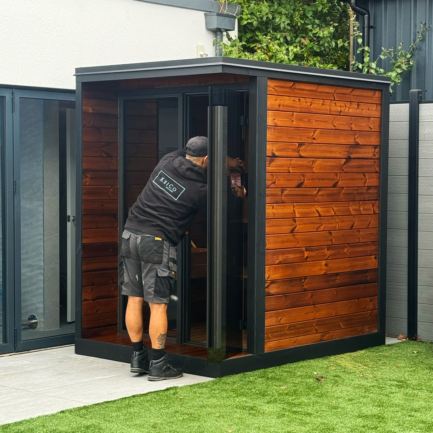 Professional KeiCo fitter carrying our on-site installation of an outdoor Sauna