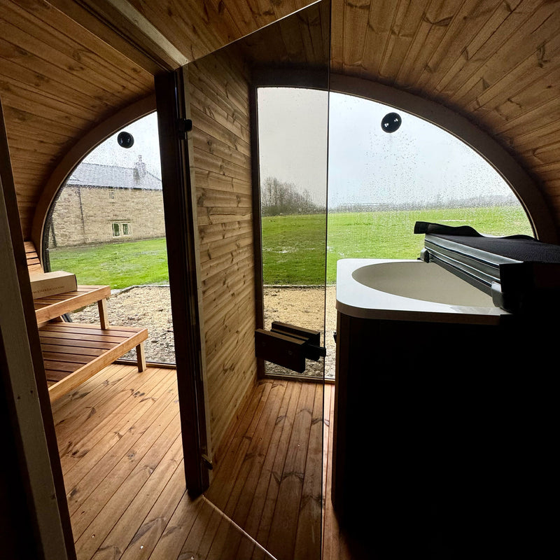 Panoramic glass sauna window inside KC Thermal Sanctum overlooking natural landscape