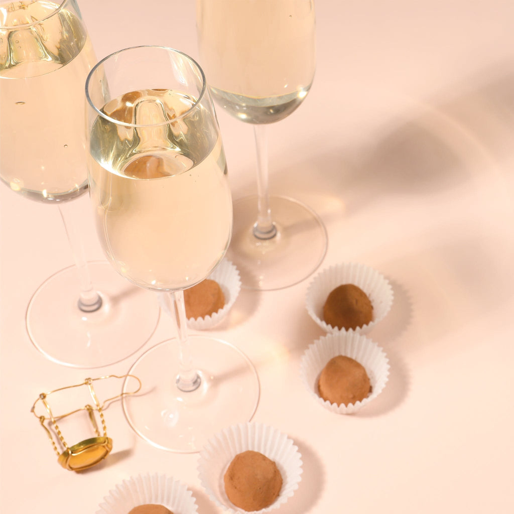 Close-up of Baglietti's sparkling prosecco and Jacquot's chocolate truffles, a decadent pairing.