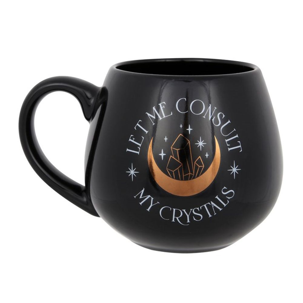 Let Me Consult My Crystals' Black Mug with bold lettering and golden crescent moon design.