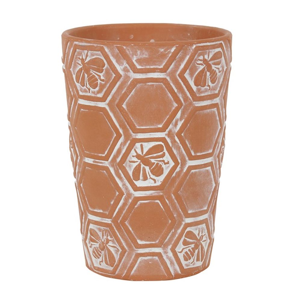 Terracotta plant pot adorned with detailed bee and honeycomb patterns, accentuated by a gentle whitewash effect.
