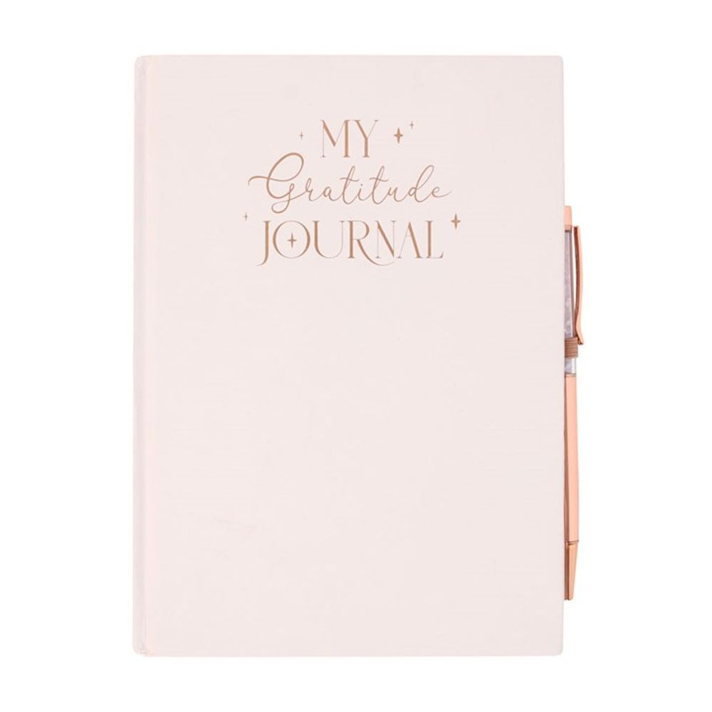 Close-up of the rose quartz chip ballpoint pen with a sleek gratitude journal.