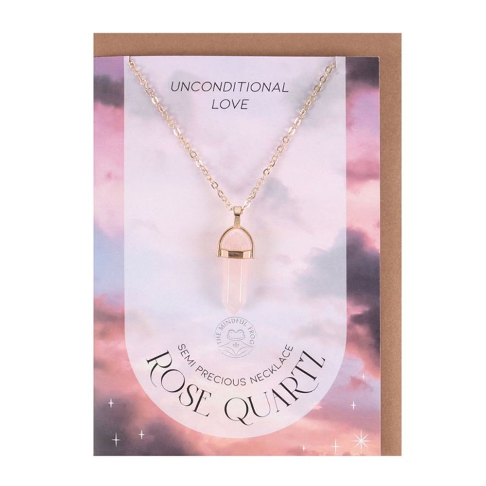 KeiCo's elegant gold-tone necklace with rose quartz pendant, draped gracefully over the blank greeting card.